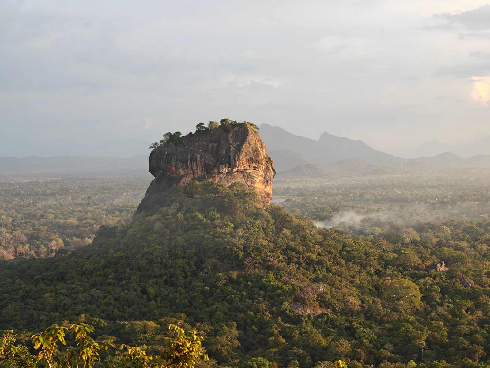Aerial view of Sigiriya Rock Fortress surrounded by green forest