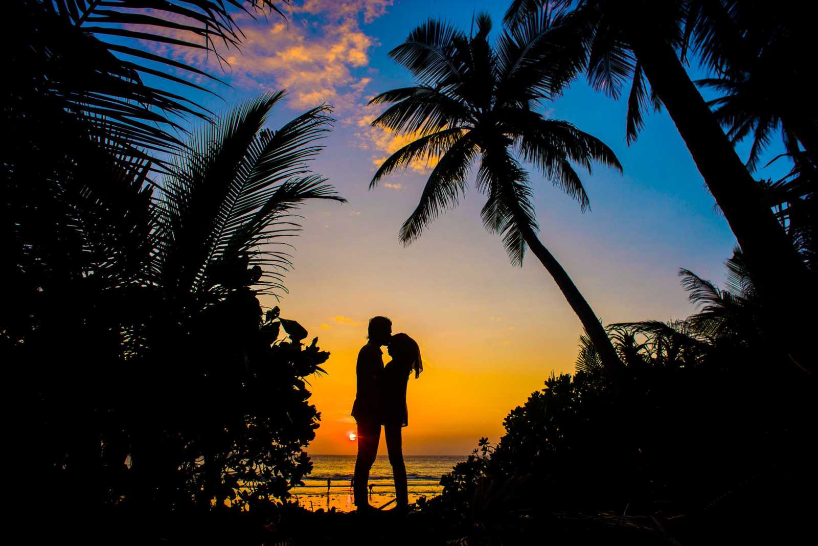 Couple walking along Unawatuna Beach in Sri Lanka